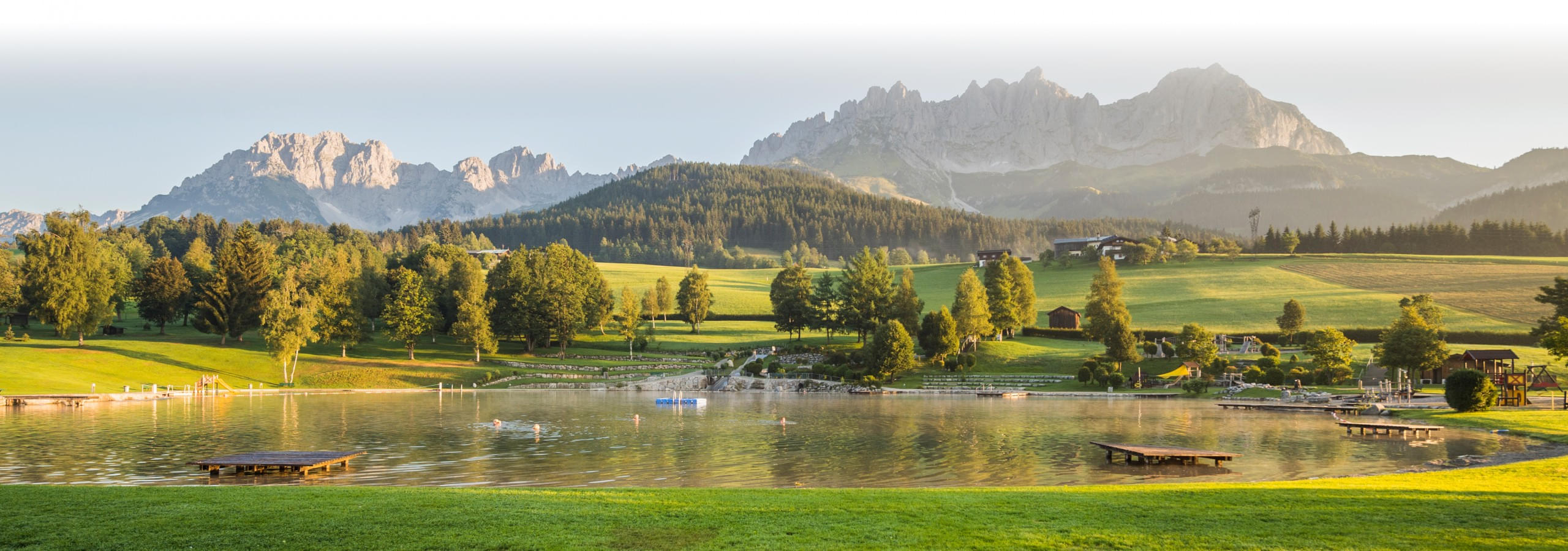 Idyllischer Badesee Going in den Kitzbüheler Alpen mit Blick auf die Berge des Kaisergebirge