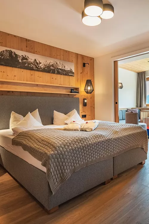 Komfortables Doppelzimmer mit Holzwand und gemütlicher Beleuchtung